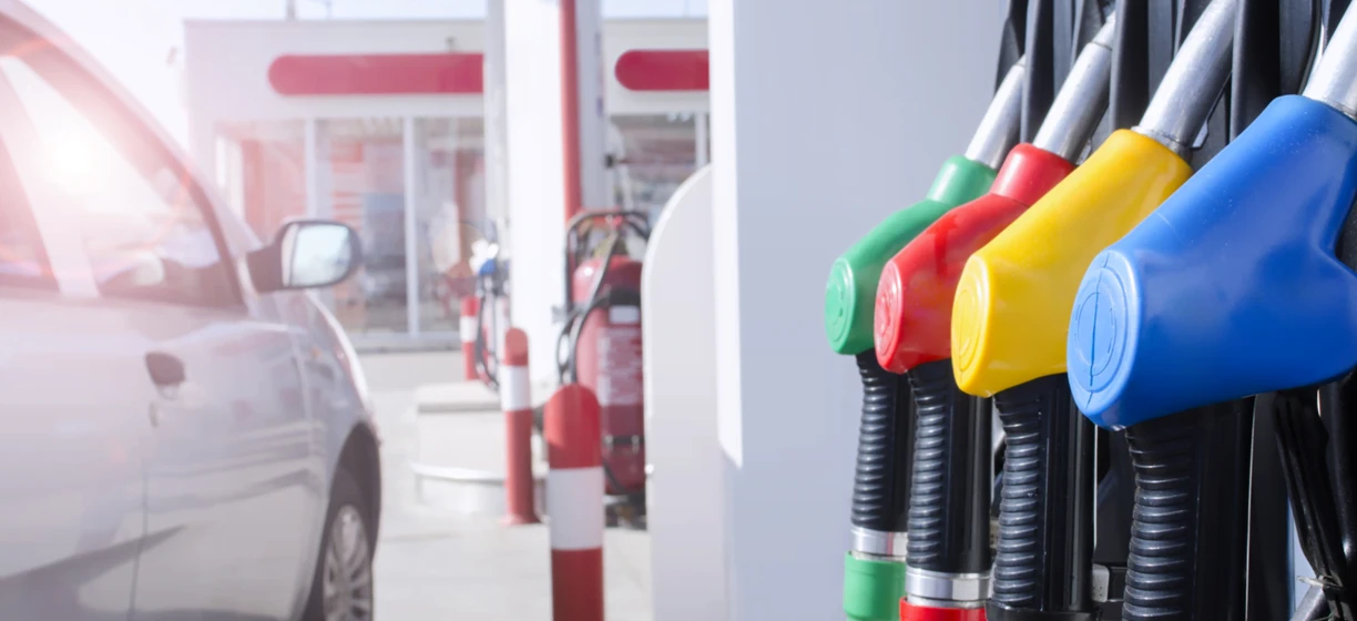 A fuel dispenser at a filling station offering gasoline, diesel fuel, and even electric vehicle charging. The machine ensures cleanliness while dispensing petroleum products.