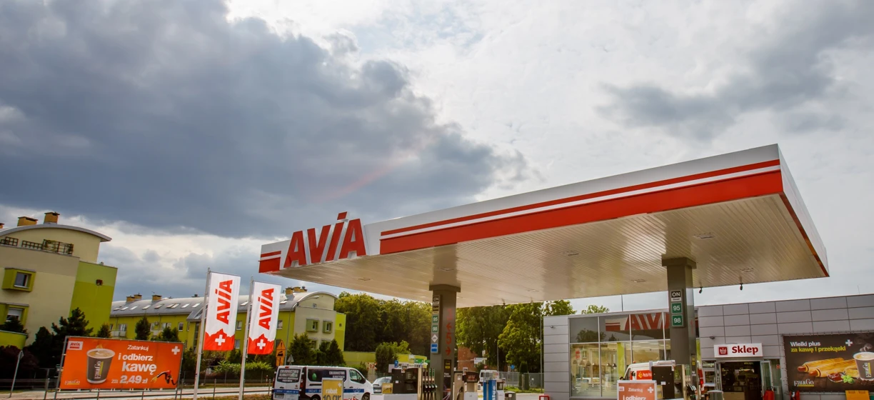 Image alt-text: Advertisement at a filling station promoting a coffee offer for 2.49 zł with fuel purchase. Keywords: Filling station, Advertising, Fuel, Zatankuj, coffee, AVIA, snack, SD Eibar.