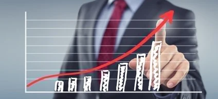 A white-collar worker in formal wear gestures with their thumb, symbolizing management or trading in a business setting.