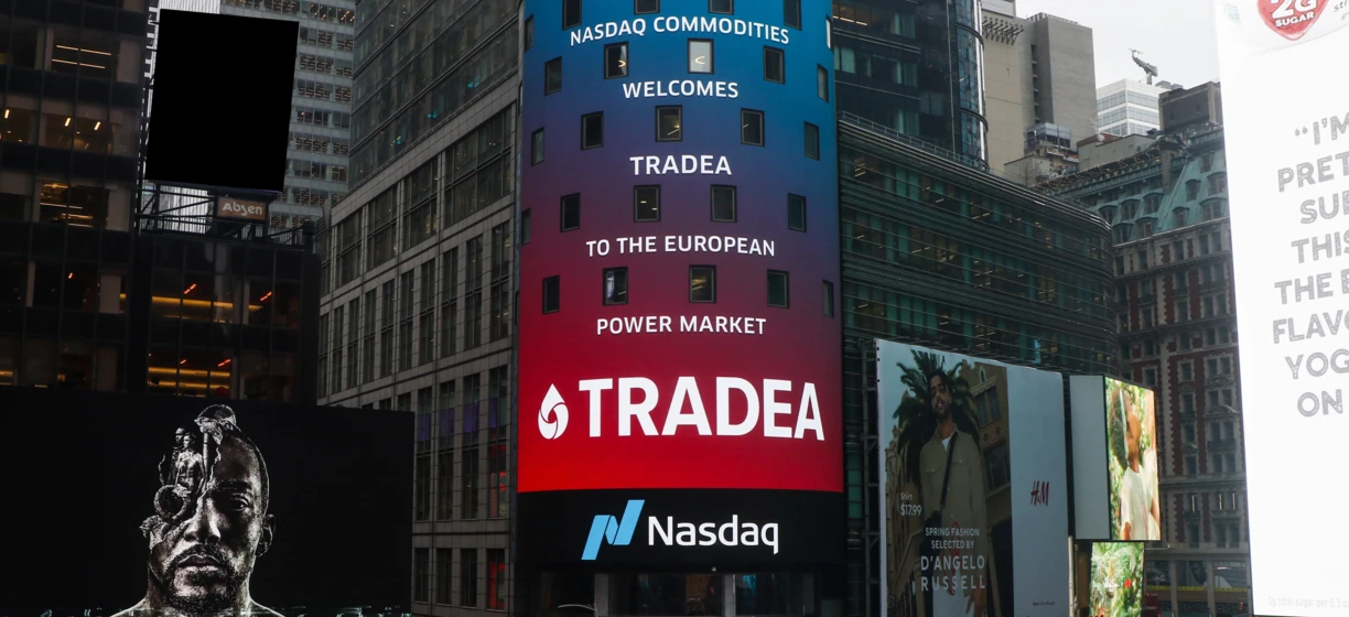 Electronic signage on a high-rise commercial building in a metropolitan area displays advertisements for Starbucks, Nasdaq commodities, and more. Skyscraper banner features logos and text including "2G total sugar" and "Spring Fashion selected by D'Angelo."