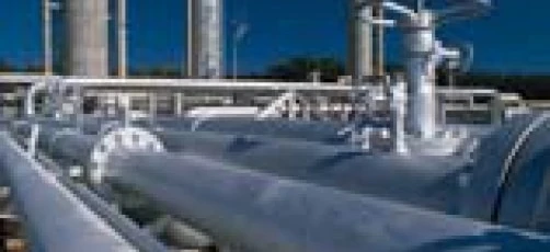 A composite material pipeline being installed in an industrial setting. Steel casing pipe being used in plumbing engineering.