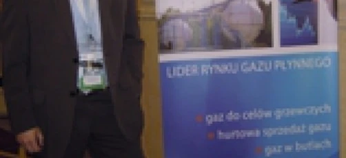 A white-collar worker in a stylish blazer and suit trousers with a dress shirt and necktie, advertising UNIMOT Gas as the leader in the market. FLF logo prominently displayed.
