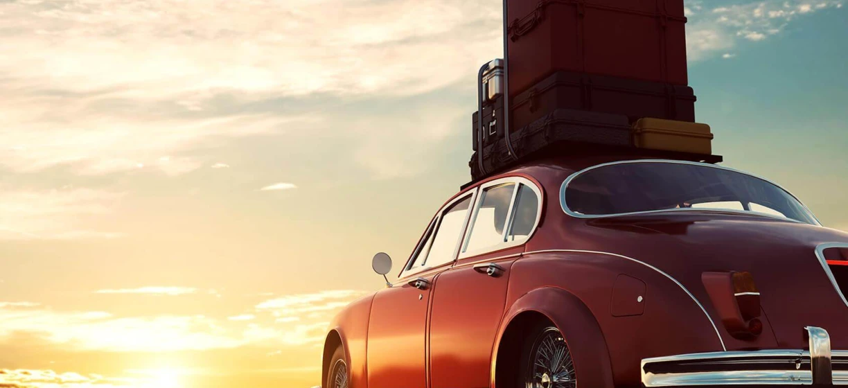 Reflection in the automotive mirror of a classic car's hood, headlamp, and grille. Antique car with a sleek design.