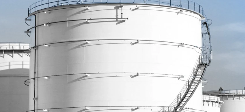 A steel storage tank in an industrial factory setting, with composite material pipes and cylinders. Industry engineering at work in a silo.