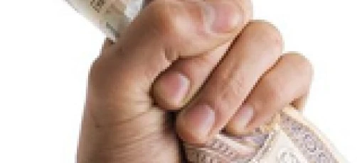 A hand counting dollars - symbolizing money handling and saving. VA 200 and 339 CH banknotes being counted.