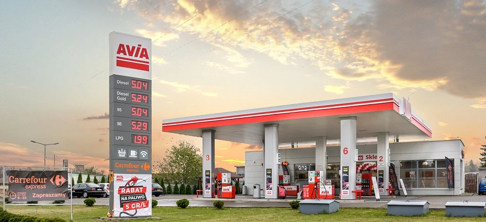 Gasoline and diesel fuel dispensers at Carrefour filling station. Various fuel prices displayed for SUVs and cars. Visit us for a discount on fuel.