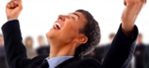 A person's hand is raised in a cheering gesture, with their thumb up, symbolizing happiness and rejoicing. They are using sign language as a form of entertainment, performing arts.