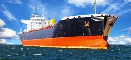 A large freight tanker ship sails across the ocean, showcasing naval architecture and the transportation industry.
