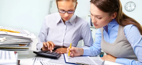 A desk with office supplies, paper and a laptop, symbolizing learning and work in a white-collar job. Perfect for students and professionals alike.