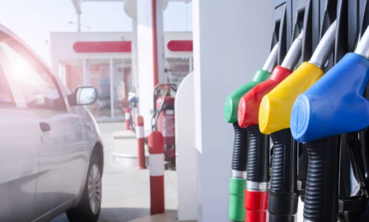 A fuel dispenser at a filling station offering gasoline, diesel fuel, and even electric vehicle charging. The machine ensures cleanliness while dispensing petroleum products.