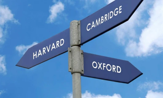 Blue street name sign bearing the words "HARVARD" in Cambridge. Cambridge Audio presents the prestigious universities in a sleek design.