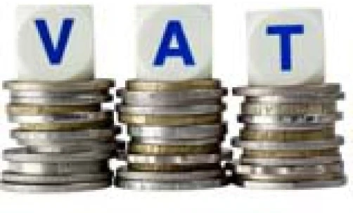 A hand holding a stack of coins and bills, representing money handling and saving for VAT expenses. Cash, currency, nickel.