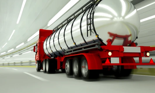 A semi-trailer truck with a storage tank for fuel or water. The commercial vehicle is equipped with an automotive wheel system for freight transport.