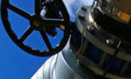 A close-up photo of a metal pipe being machined with a cylinder-like tool. The engineering process involves shaping steel, aluminium, and titanium to create precise parts for a telescope.