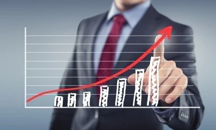 A white-collar worker in formal wear gestures with their thumb, symbolizing management or trading in a business setting.