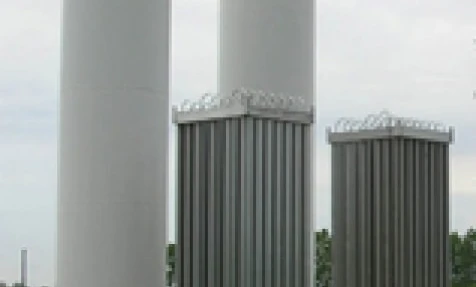 A steel cylinder storage tank made of composite material in an industrial setting. Engineering and industry concept with steel and aluminium silo.