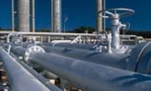 A composite material pipeline being installed in an industrial setting. Steel casing pipe being used in plumbing engineering.