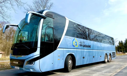 A commercial MAN tour bus with windscreen wipers travels as a mode of public transport in Ukraine. MAN PZ 903VT Lion's Coach Hlift.