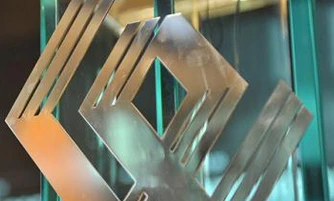 A modern graphic design of metal and glass with striking symmetry. Featuring a sleek aluminium finish and bold ונ typography.