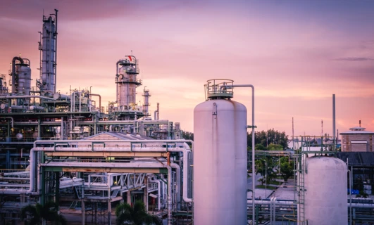Fabryka z przemysłowymi rurociągami, zbiornikami magazynowymi, stalowymi cylindrami i wysokim kominem dostarczającym energię elektryczną w elektrowni. Inżynieria w swojej najlepszej formie.