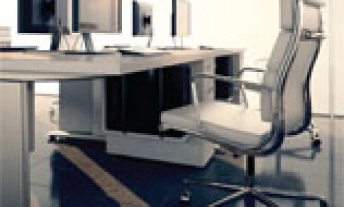 Modern office with sleek furniture including a comfortable chair, large computer desk, and computer monitor. Elegant interior design with a focus on functionality.
