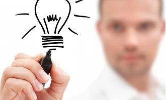 A businessperson happily holding a light bulb, symbolizing innovation in a modern office setting. Gesture of success in a polished workspace.