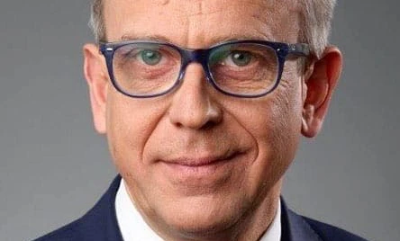 A person wearing eyewear rests their chin on their hand, their glasses perched on their forehead, framed by their cheek and eyebrow. Vision care for a clear-sighted face.