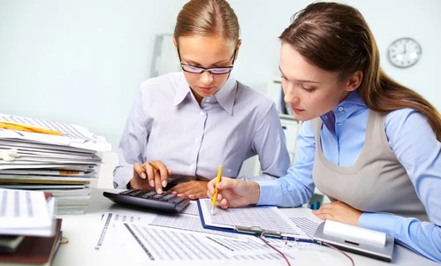 A desk with office supplies, paper and a laptop, symbolizing learning and work in a white-collar job. Perfect for students and professionals alike.