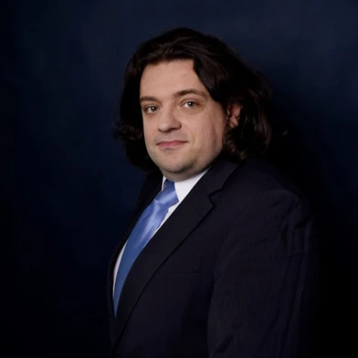 A white-collar worker with a serious facial expression, wearing a dress shirt and blazer. Focus on chin, cheek, eyebrow, and forehead.