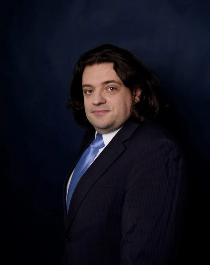 A white-collar worker with a serious facial expression, wearing a dress shirt and blazer. Focus on chin, cheek, eyebrow, and forehead.